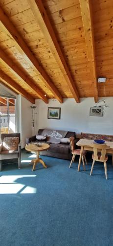 a living room with a couch and a table at Landhaus Thaler in Mittelberg