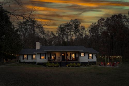 a house at night with the lights on at THE ULTIMATE SMOKY MOUNTAIN ESCAPE! Game Room, Theater, Hot Tub, Fire Pit & the Ultimate in Luxury Living - Close to All Major Top Attractions in Pigeon Forge