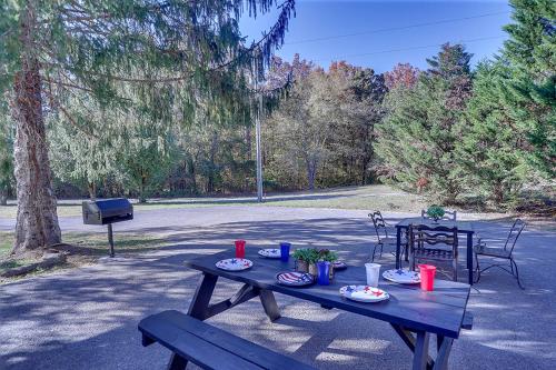 a picnic table with plates of food on it at THE ULTIMATE SMOKY MOUNTAIN ESCAPE! Game Room, Theater, Hot Tub, Fire Pit & the Ultimate in Luxury Living - Close to All Major Top Attractions in Pigeon Forge