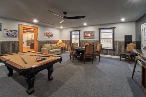 a living room with a pool table and chairs at THE ULTIMATE SMOKY MOUNTAIN ESCAPE! Game Room, Theater, Hot Tub, Fire Pit & the Ultimate in Luxury Living - Close to All Major Top Attractions in Pigeon Forge