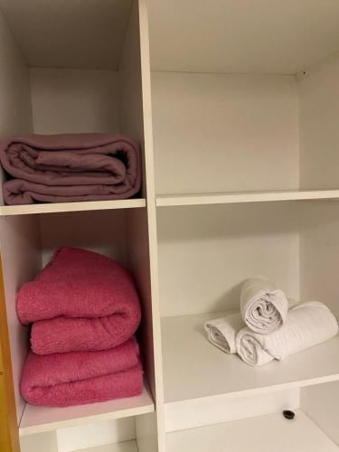 a towel organizer with pink towels in it at Complejo Pampa 1 in Santa Rosa