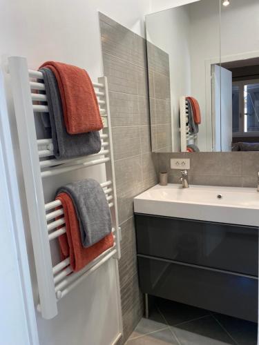 a bathroom with a sink and a mirror and towels at LA DOLCE VITA MAZET A GASSIN GOLFE DE SAINT TROPEZ in Gassin