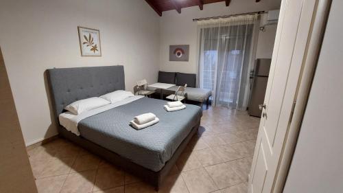 a bedroom with a bed with two towels on it at Studios Voula in Malakóndas