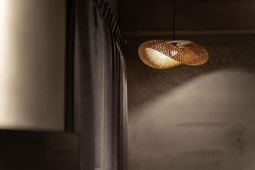 aendant light hanging from a wall next to a window at 全村的希望Hope of village in Dongshan