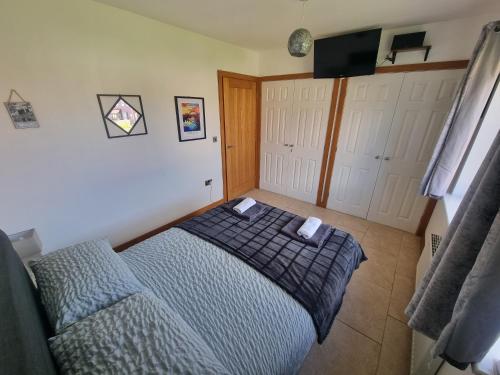 a bedroom with a bed and a flat screen tv at The Priory - 1 mile from Ramside Hall Hotel Spa and Golf & A1 in Durham