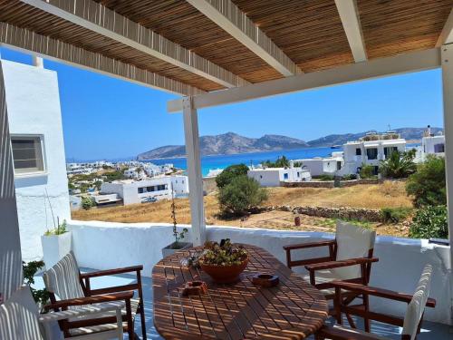 a table on a patio with a view of the ocean at Melissa Chora in Koufonisia