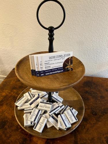 a shelf with a book and a pile of money at Gasthof Sternen Detligen in Detligen