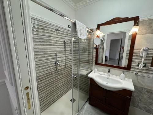 a bathroom with a shower and a sink and a mirror at Blue Sky in Tropea
