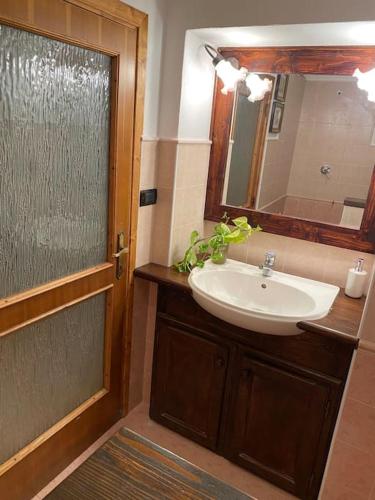 a bathroom with a sink and a shower with a mirror at Casa Vacanze Fonte del Menotre in Foligno