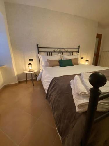 a bedroom with a large bed and a side table at Casa Vacanze Fonte del Menotre in Foligno