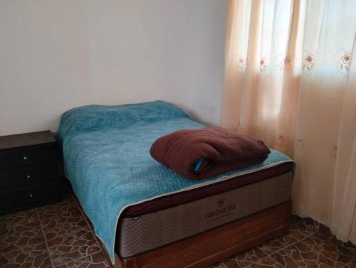 a bed with a red towel on top of it at Casa Valle de Sur in Durango