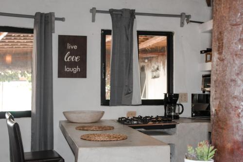 a kitchen with a counter with two cookies on it at RUSTICO LOUNGE-Property in front of the beach in San José del Cabo
