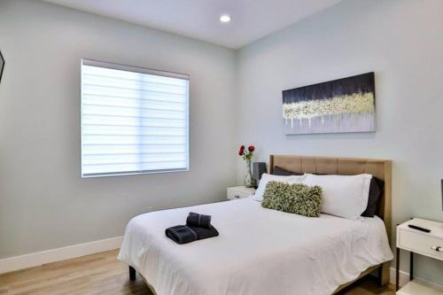 a white bedroom with a large bed and a window at H&H New Built 2023 Hidden Gem Heart of OC 3 Queen Beds in Westminster