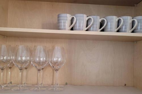 a row of wine glasses sitting on a shelf at H&H New Built 2023 Hidden Gem Heart of OC 3 Queen Beds in Westminster