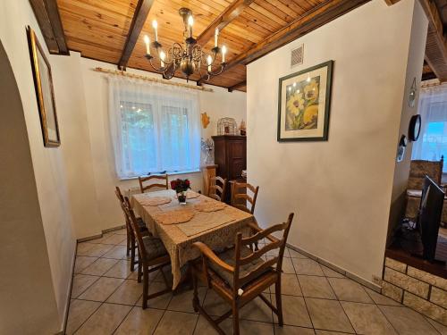 a dining room with a table and chairs at Ferienhaus JULKA am See mit Kamin & WLAN - Domek Letniskowy JULKA in Teerau