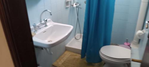 a bathroom with a toilet and a sink at Hotel zakros rooms-restaurant in Zákros