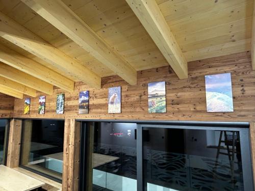 a room with wooden walls with pictures on the wall at Horska Rezort in Ružomberok