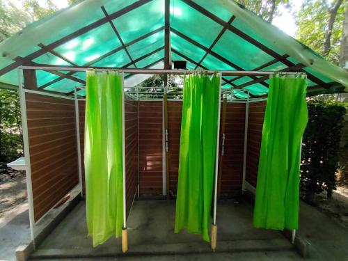 a large green canopy over a small house with a porch at Happy Camping Arrecifes dentro del Parque Nacional Natural Tayrona in El Coquito