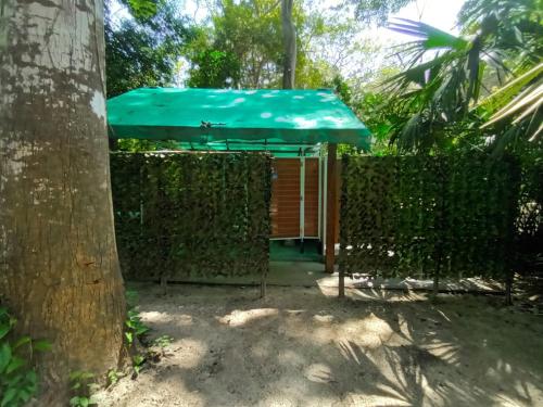 a blue umbrella sitting on top of a fence at Happy Camping Arrecifes dentro del Parque Nacional Natural Tayrona in El Coquito