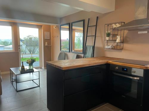 a kitchen with a wooden counter top in a room at FIVE Apartments - Boutique in Tromsø