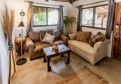 a living room with two couches and a coffee table at RUSTICO LOUNGE-Property in front of the beach in San José del Cabo