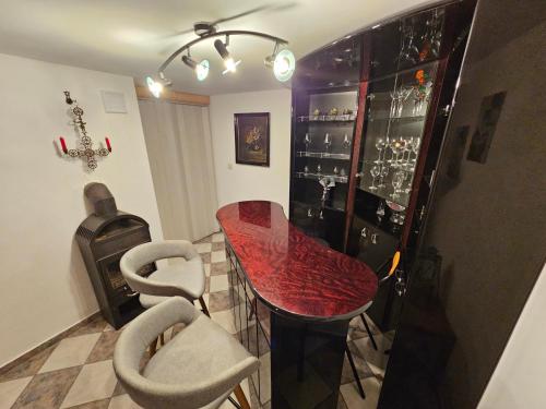 a dining room with a red table and chairs at Ferienhaus JULKA am See mit Kamin & WLAN - Domek Letniskowy JULKA in Teerau