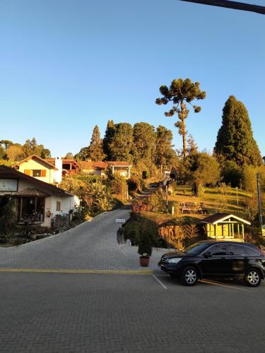 een auto geparkeerd aan de kant van een weg bij Chalés Lanelli in Monte Verde