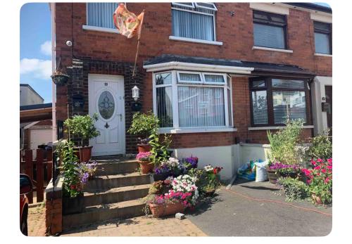 a brick house with flowers in front of it at Mournview in Belfast
