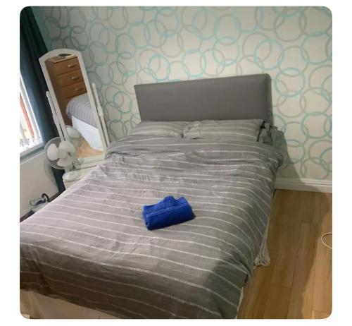 a blue bag sitting on top of a bed at Mournview in Belfast