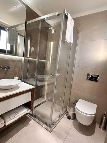 a bathroom with a shower and a toilet and a sink at S&S Business Park in Mağusa
