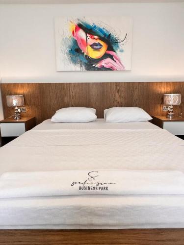 a bedroom with a bed with a white bedspread at S&S Business Park in Mağusa