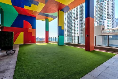 a large room with a green floor in a building with tall buildings at Vibrant Downtown Miami Gem - 2BR, near Port of Miami & Entertainment in Miami