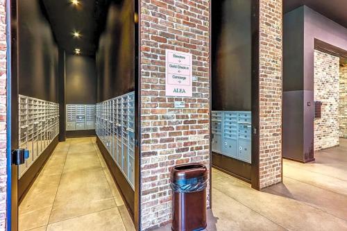 a hallway with a brick wall and a trash can at Vibrant Downtown Miami Gem - 2BR, near Port of Miami & Entertainment in Miami