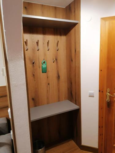 a room with a wooden wall with a shelf at Haus Bergliebe in Filzmoos