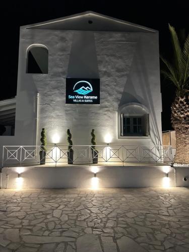 a building with a sign on the side of it at night at Sea View Kerame in Évdhilos