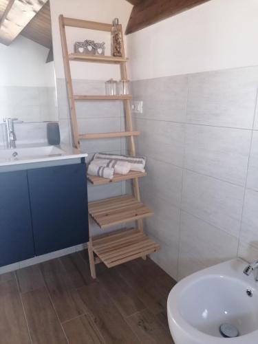 a bathroom with a white sink and a toilet and a sink at Ca' Libellula Casa Vacanza in Avola