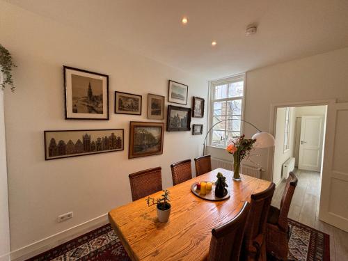 a dining room with a wooden table and chairs at Luxury House With 2 Private Independent Studios 120 m2 Near LEIDSEPLEIN CITY CENTRE AMSTERDAM - Paid Parking Possibilities Nearby in Amsterdam