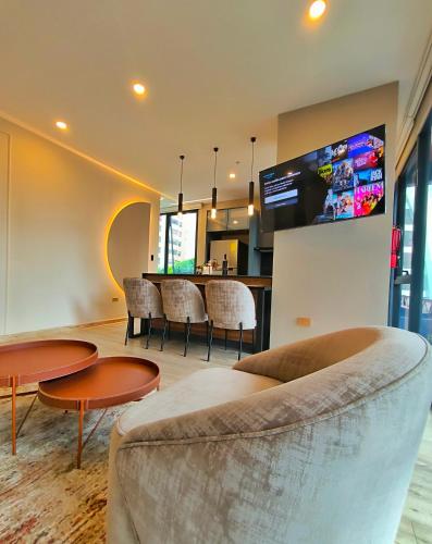 a living room with a couch and tables and a bar at Republica del Salvador Coliving Ecuador XOE in Quito