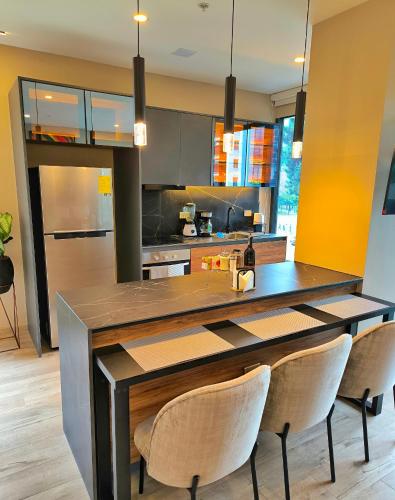 a kitchen with a large wooden table with chairs at Republica del Salvador Coliving Ecuador XOE in Quito