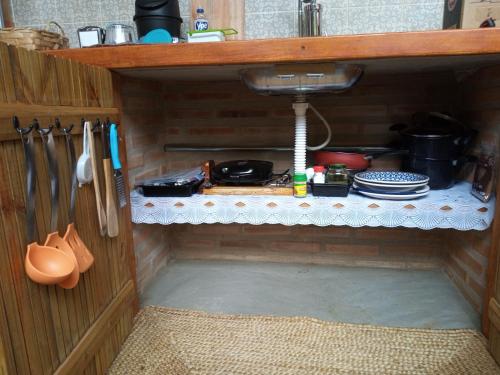 a kitchen with a sink and a counter top at Recanto Curiaçu in Cunha