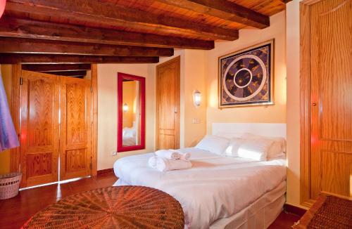 a bedroom with a large bed with towels on it at Atico Preciados in Madrid