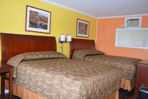 a hotel room with two beds and a window at Harmony Inn in Goderich