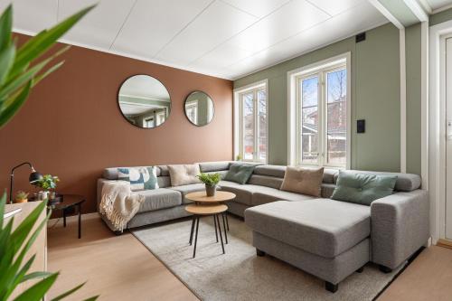 a living room with a couch and a table at Central and newly renovated apartment for rent in Tromsø