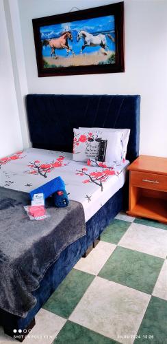 a bedroom with a bed and a table at HOTEL NUEVO GALEX in Acacías