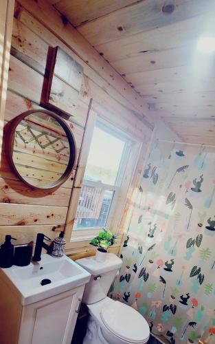 a small bathroom with a toilet and a window at Lake Victoria Resort in Alexandria