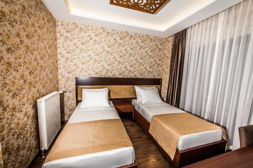 a hotel room with two beds and a window at My Green Boutique Hotel in Sapanca