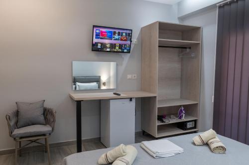 Uma TV ou centro de entretenimento em Hotel Porti