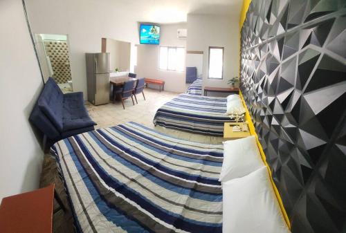 a large room with two beds and a living room at Casa Habitación Frida Valentina in Tequila