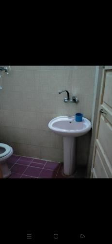 a bathroom with a white sink and a toilet at Santa Maria in Marsa Matruh
