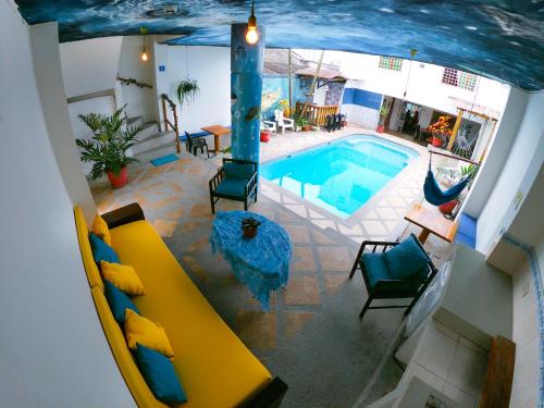 an overhead view of a swimming pool with a yellow couch at Hotel Estación del Sol in Las Núñez